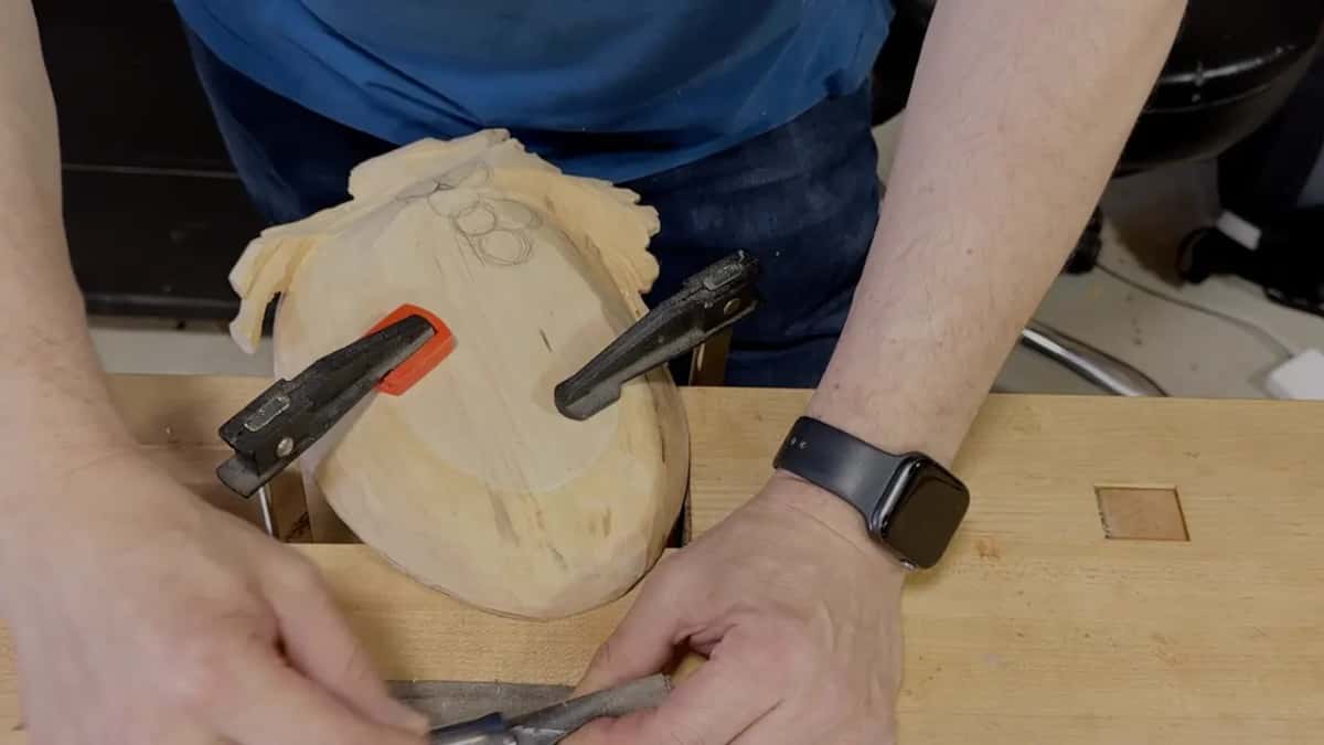 Two clamps grip the tray face down