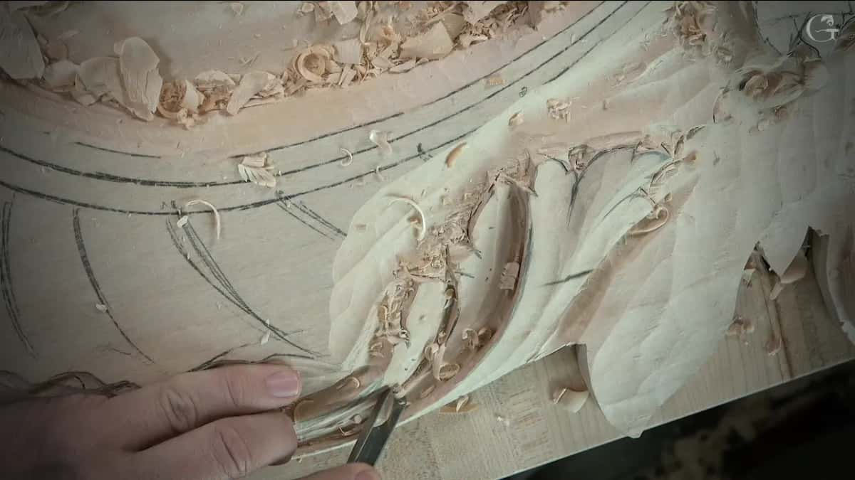 Gouge set into the bottom of the curl, fingers wrapped round the steel