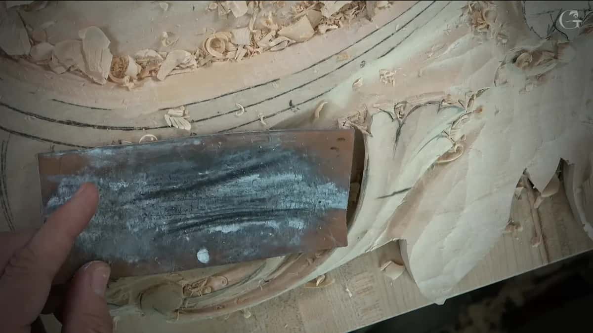 Leather strop held flat above the carving
