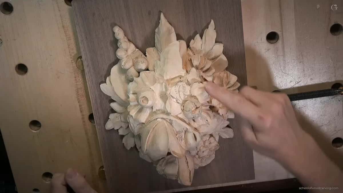 One finger points into the flowers at the upper right