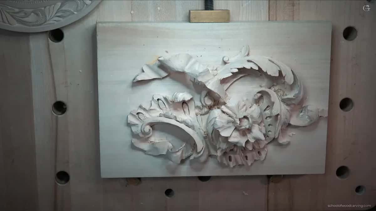 Just the panel, with leaves curling around one scroll and one flower