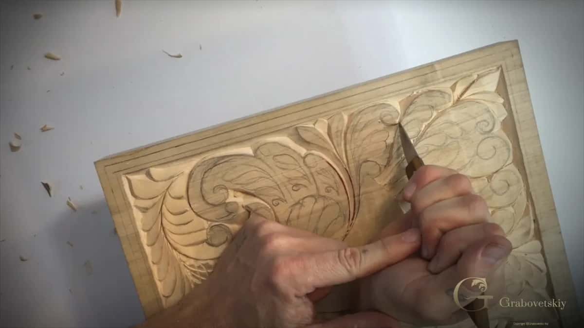 Point of the knife down in a groove on a tilted board, my left index finger pressed against the other hand