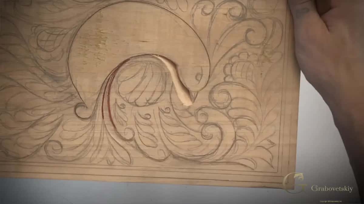 Carved groove curving under the bird's head, with a red line marked on the wing and the board seen whole