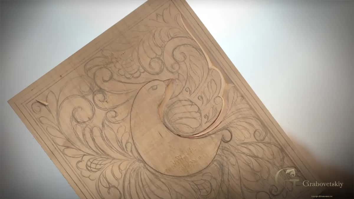 Board tilted on the white bench, the wing ringed by a carved groove