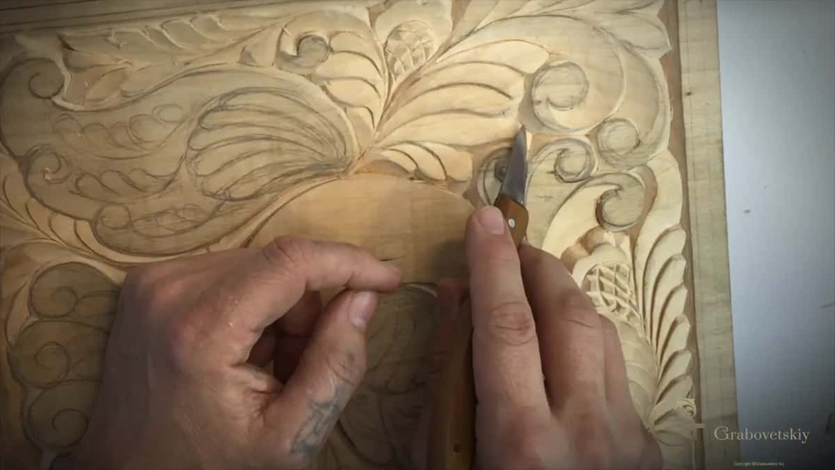 Point of the knife at a narrow line along the top of the bird