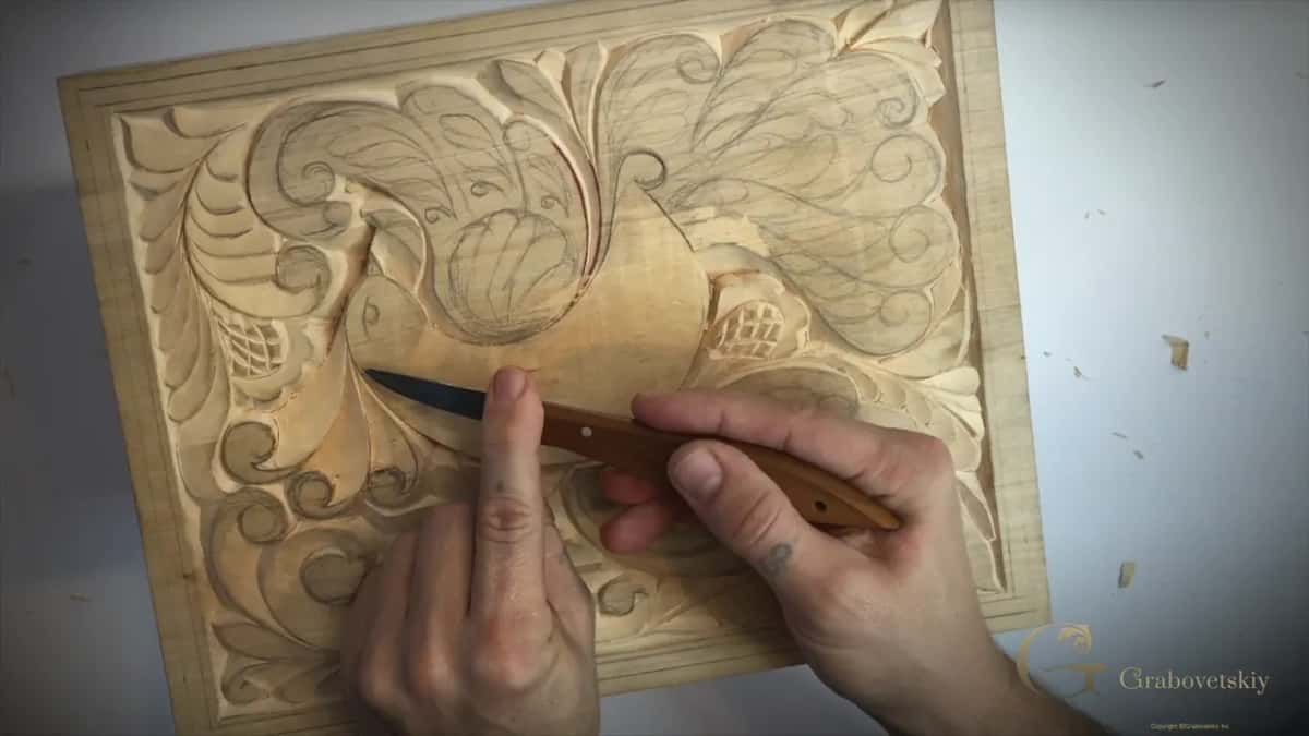 Almost flat to the wood, the knife moves while a finger of my other hand rests on the board