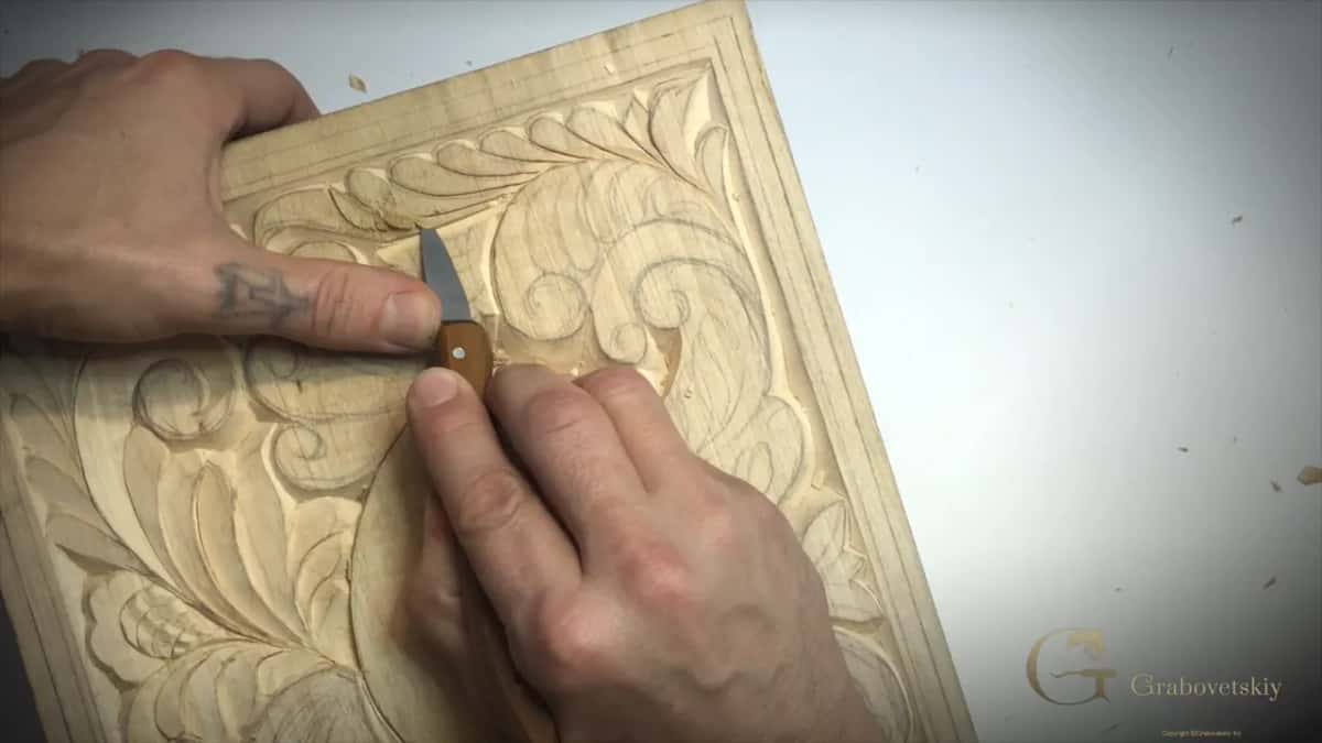 Left thumb pressing the back of the blade