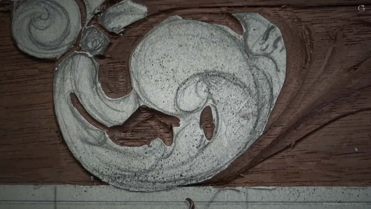 Paper pattern still on the scroll, the outline already carved around it