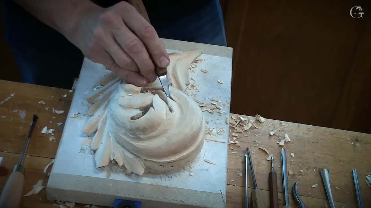 Right hand works a small tool at the top of the curl