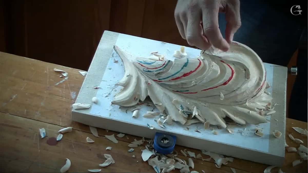 A hand hovers over lobes that now carry hollows and ridges, red and blue marks still on them