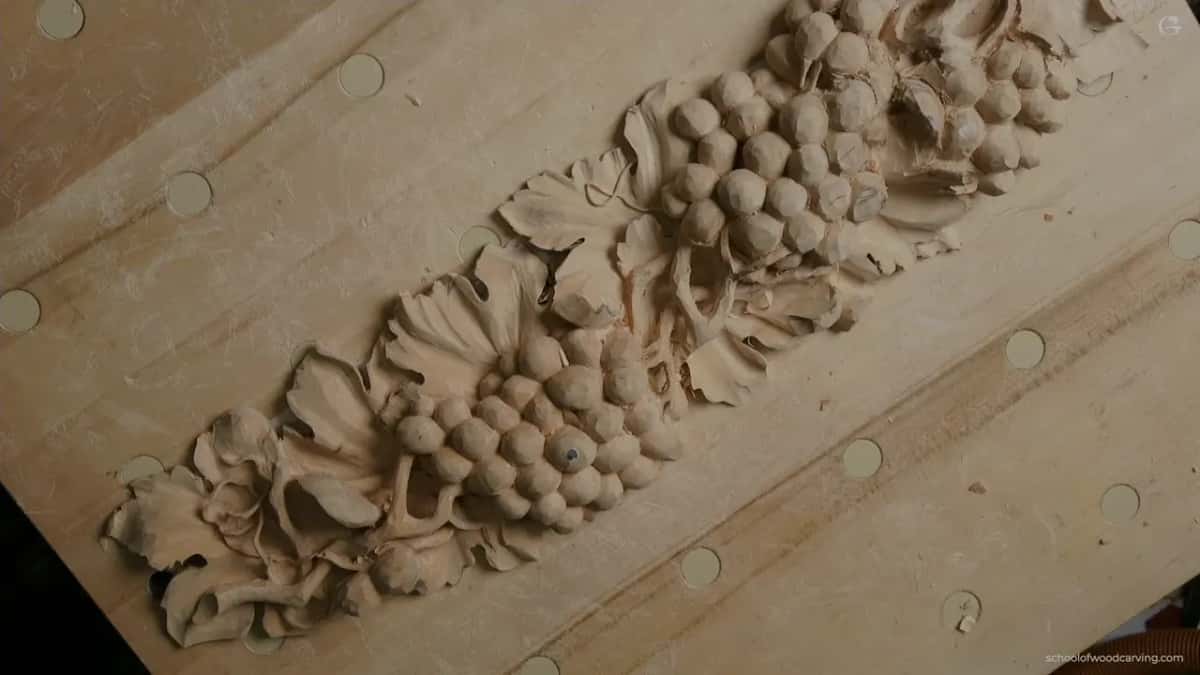 The whole panel at an angle, its grapes and leaves still rough