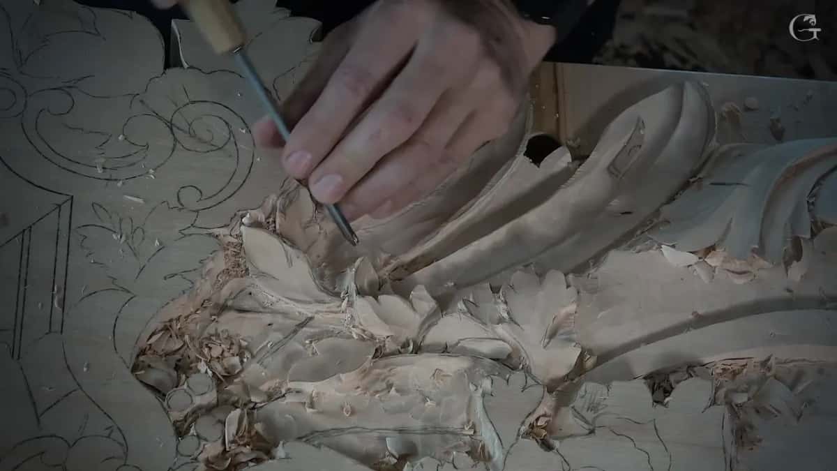 Slim tool with a pale handle, its tip down among the small leaves