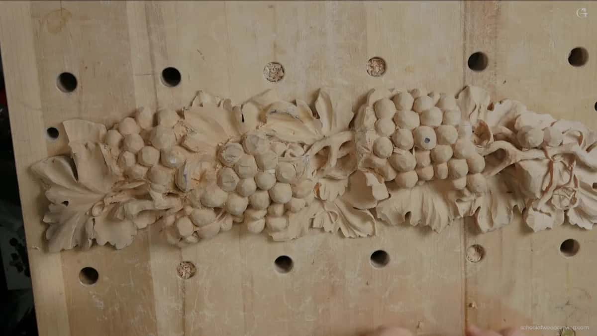 The whole grape panel from above, flat on a bench full of round holes, with no clamps on it