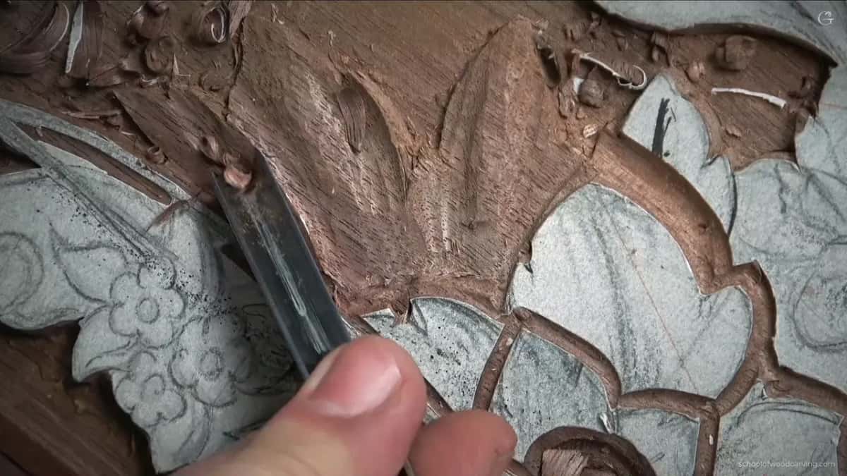 Gouge along the edge of a carved leaf, paper still on the leaves around it
