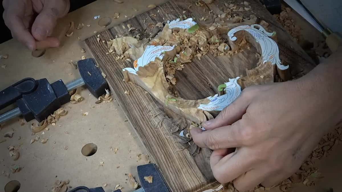 Fingertips at the foot of the scroll