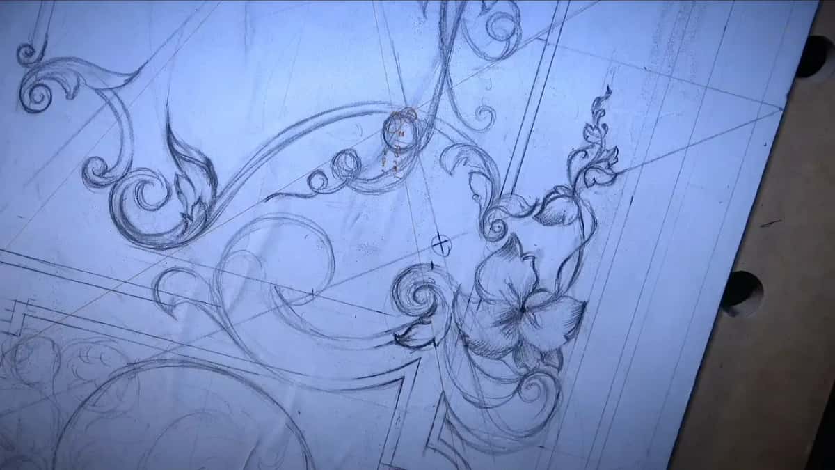 No hand in the frame, and a big shaded flower with a leafy sprig rising above it