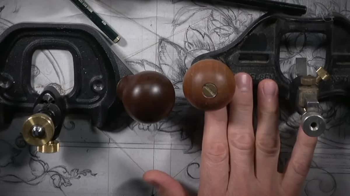 Two router planes side by side on the panel, black castings with brown knobs and brass adjusters