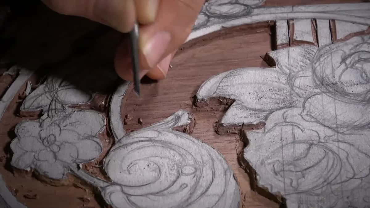 Fingertips hold a narrow tool upright