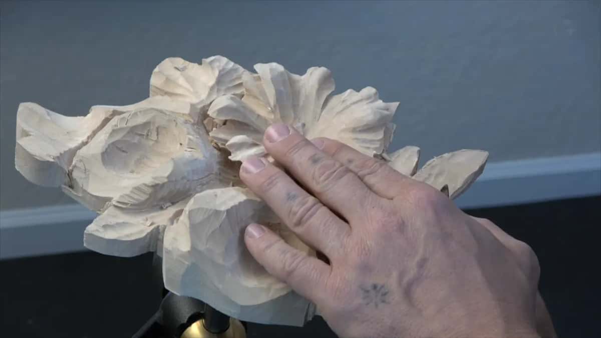 Open hand resting flat on the carving