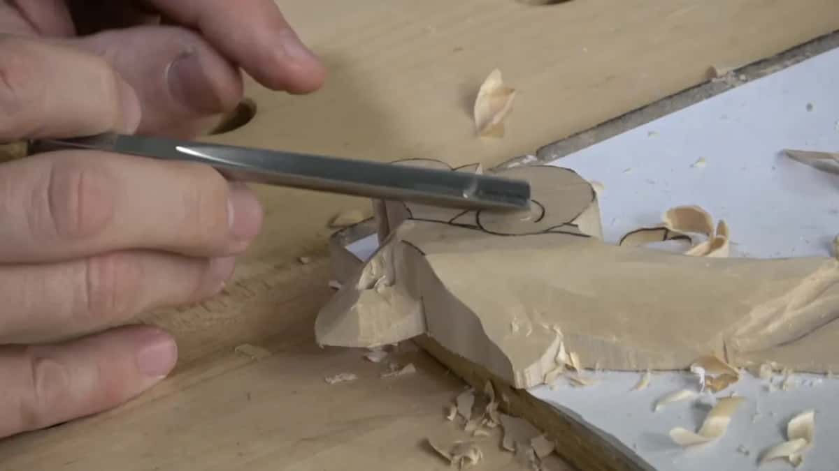 Fingers guide a slim tool over the drawn eye