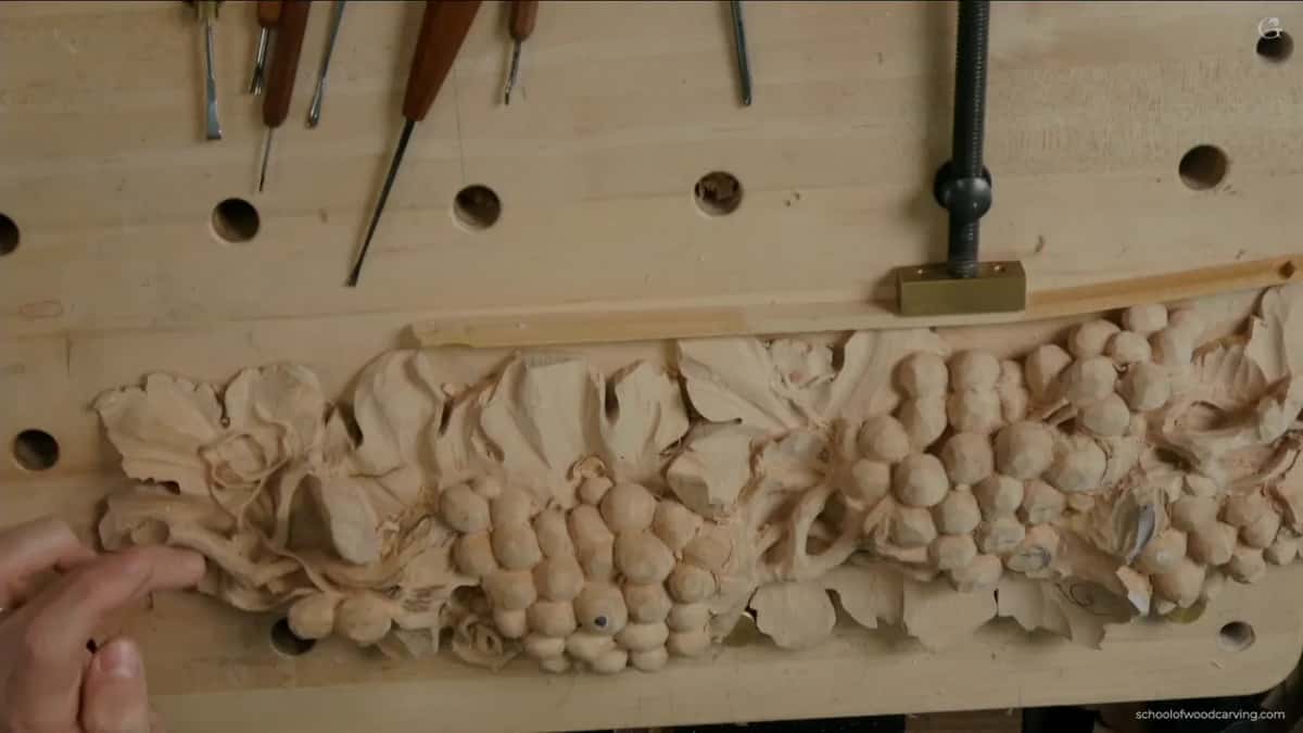 Whole grape panel seen from above on the bench, one hand reaching in at the lower left corner
