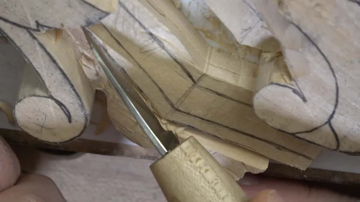 A wood handle, and a thin blade working in the corner next to the scroll.