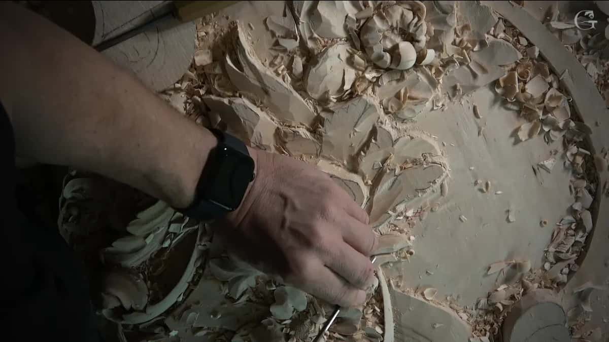 A watch on the wrist, a small tool in one leaf, flowers above