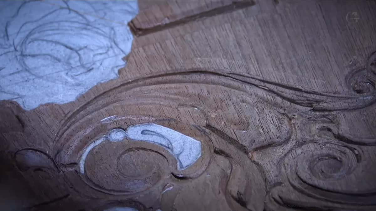 Pale blue patches on a dark carved panel
