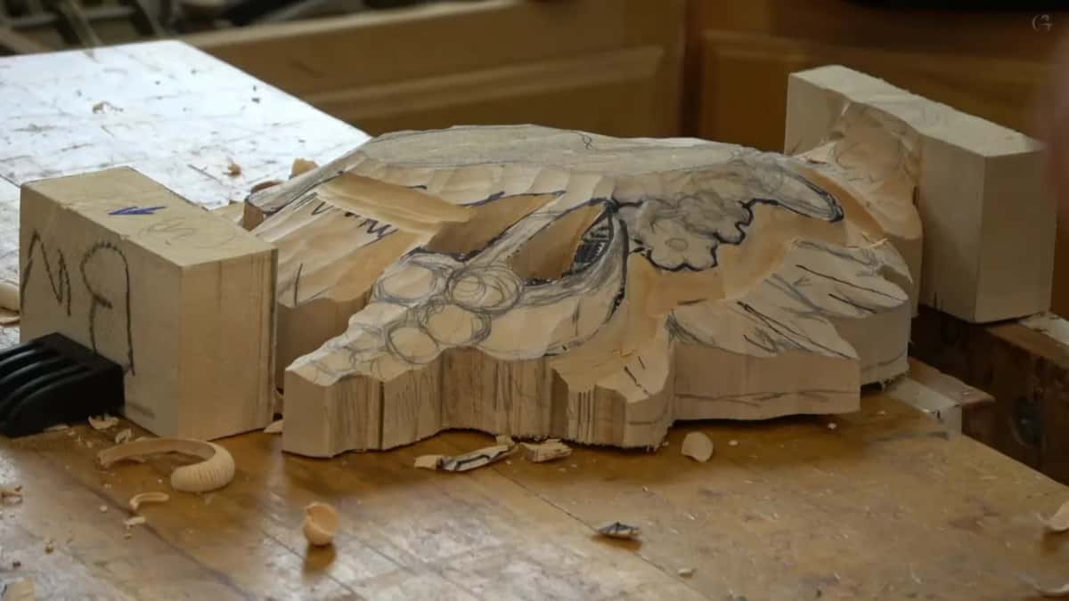 Whole carving on the bench with pencil circles below an inked flower