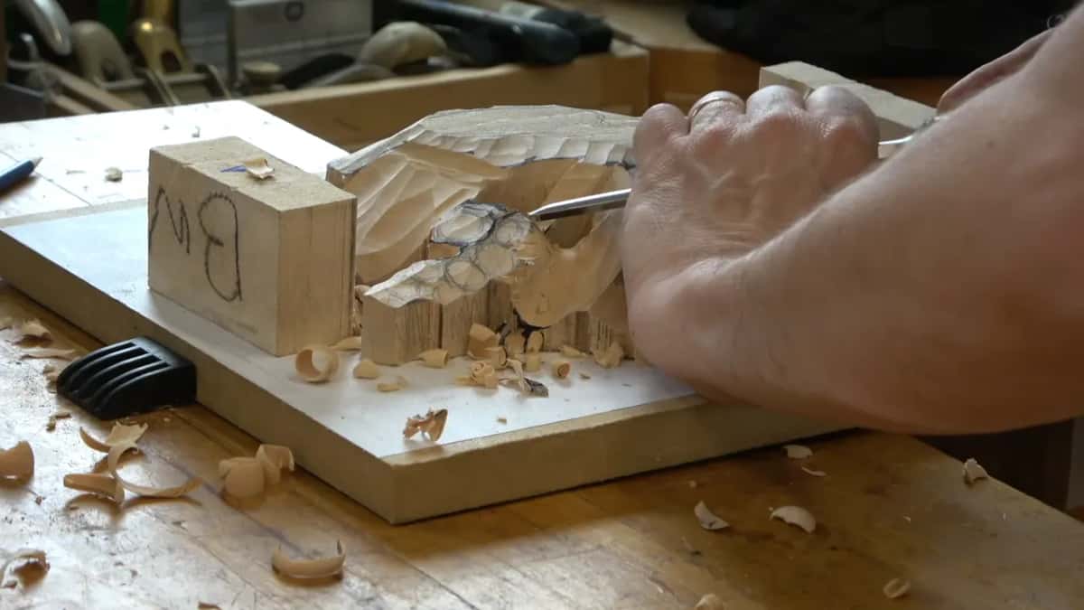 Right hand driving a gouge into the cluster