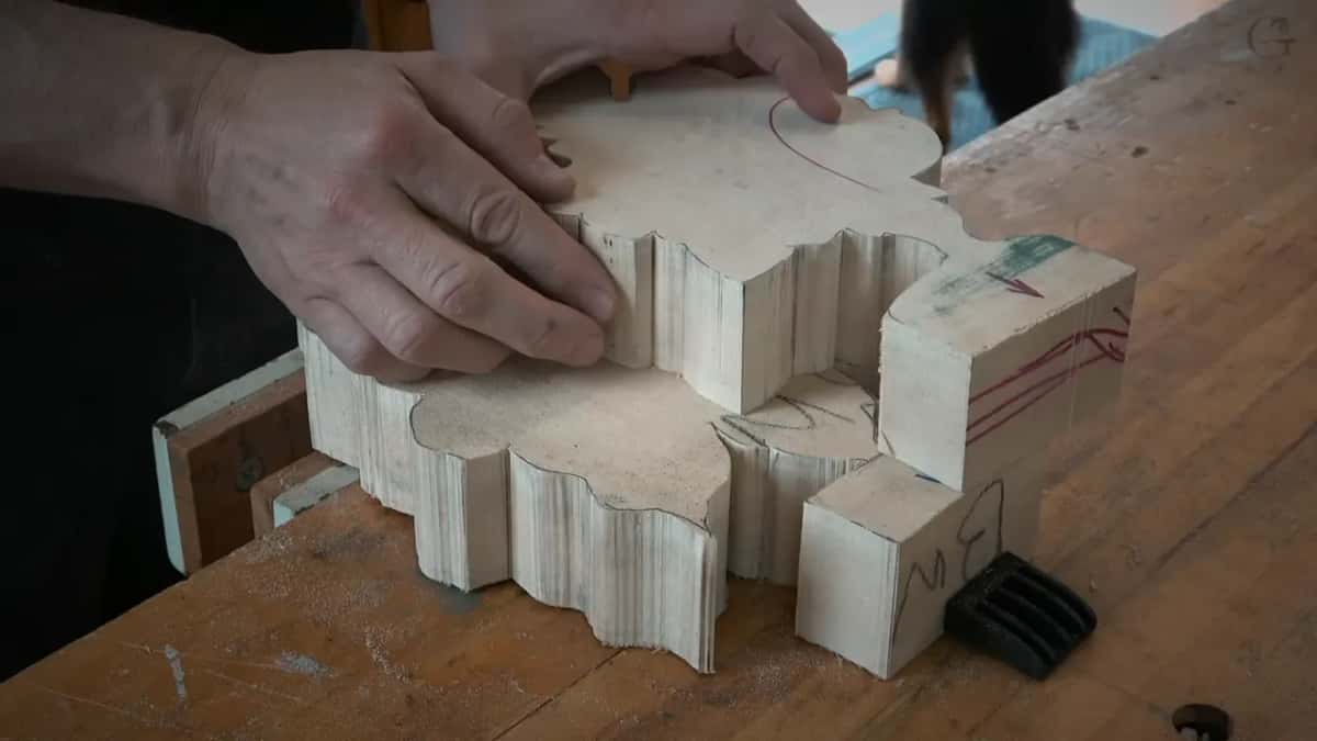 Two sawn blanks, one on the other, a hand flat on top