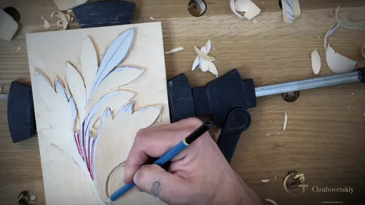 Pencil redrawing lines on the roughed leaf, seen from above
