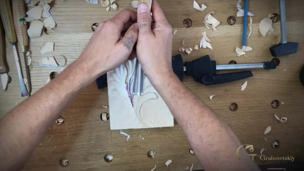 Both forearms on the bench and both hands round one upright tool
