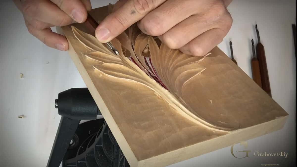 Two hands, one small gouge