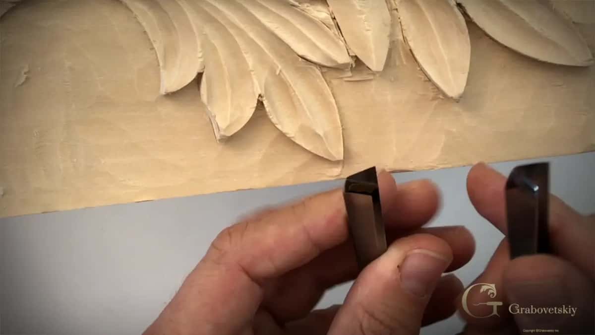 Two V tools held up in front of the leaf, ends toward the camera