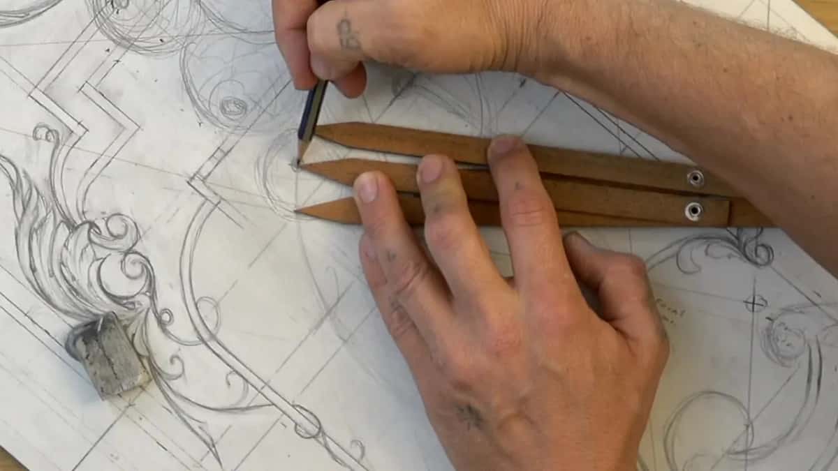 Three-armed caliper of wood with brass pins, a pencil marking where one arm lands