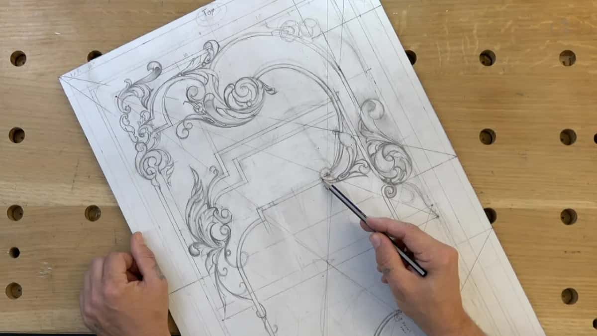 Black pencil set on a crossing of lines right of center, the left hand low on the sheet