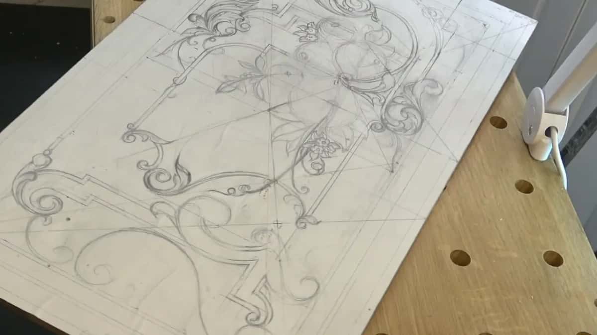 Nobody at the bench, just the drawing tilted beside a lamp