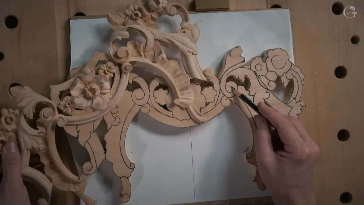 The carved first piece beside the new blank while a pencil marks it