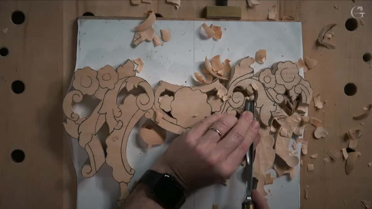 From above, a gouge stands upright in the middle of the blank among shavings