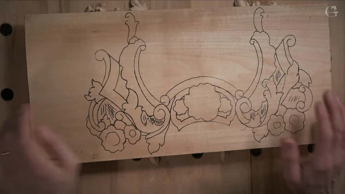 Design drawn across the board, both hands holding its edges