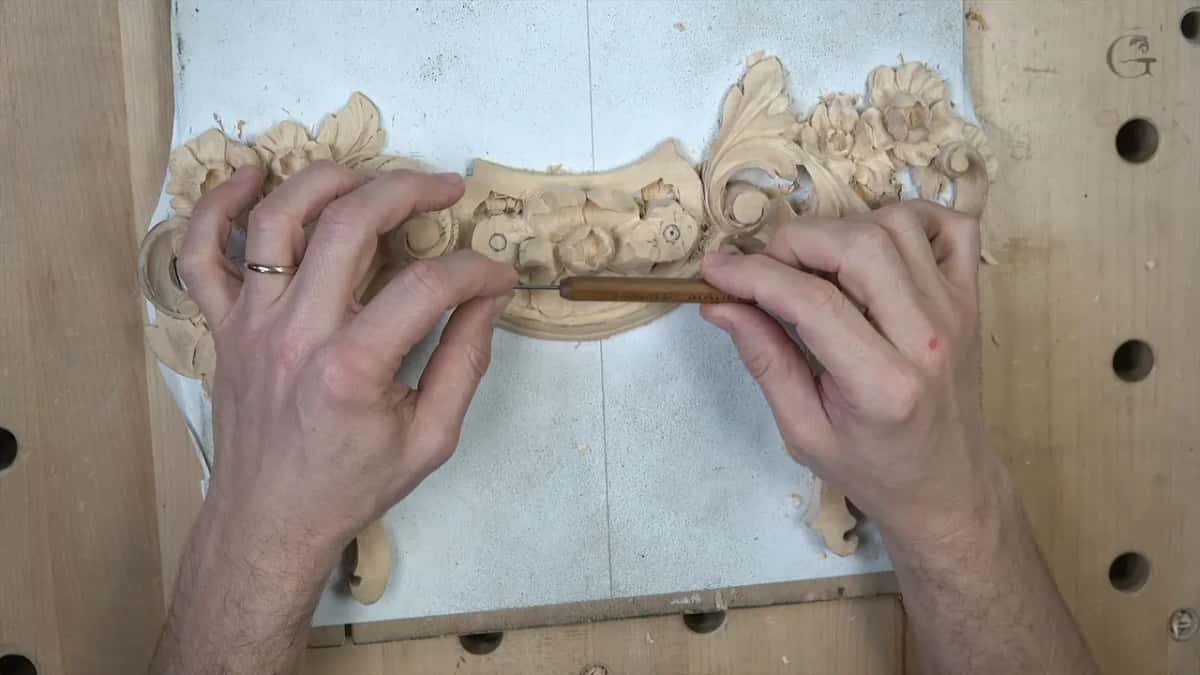 Slim brown-handled tool held flat in two hands