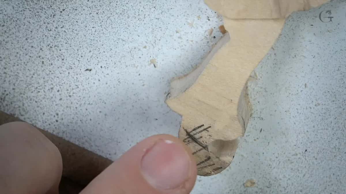 Pencil hatching near the end of a small piece, a thumb beside it