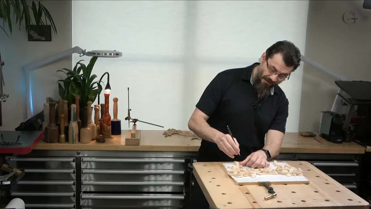 Marking the carving with a pencil at the bench