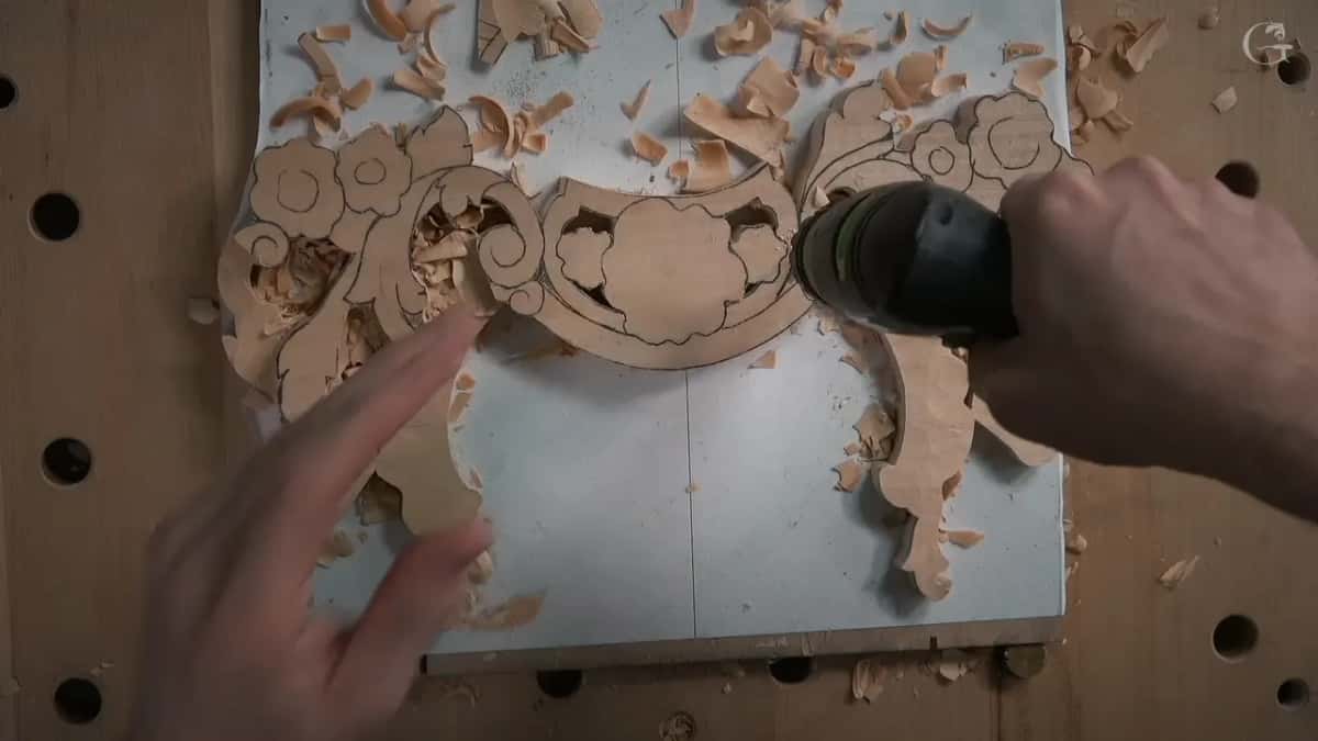 Drill in one hand, a finger pointing
