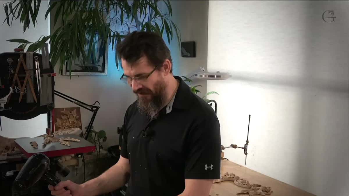 Black hair dryer in his right hand