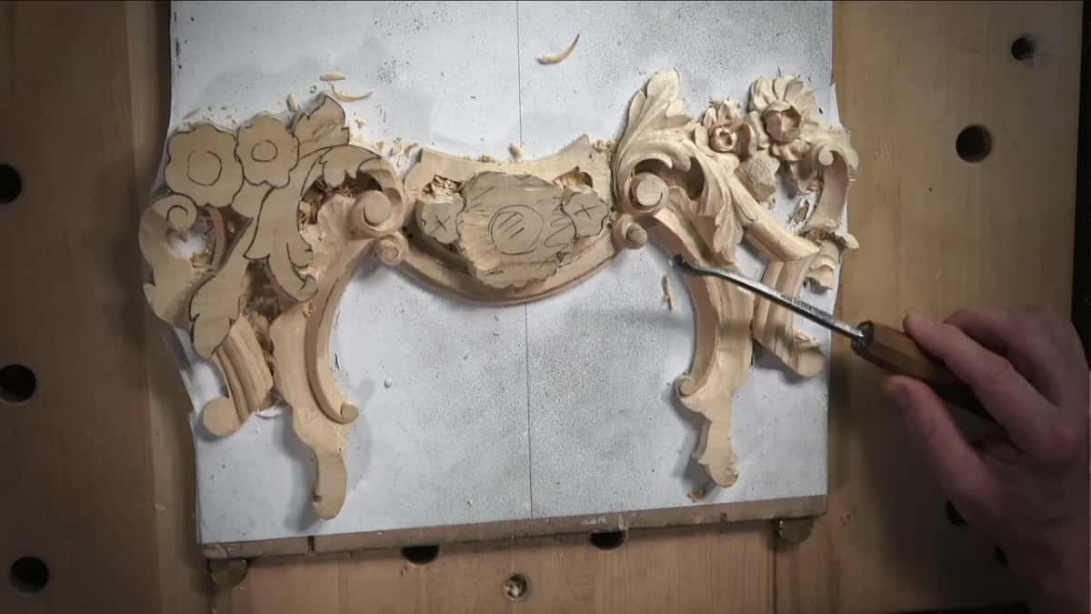 The whole panel from above, a long gouge in a right hand at one scroll