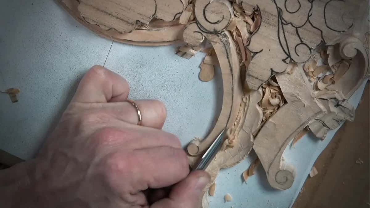 A small gouge rolling the scroll of one volute into shape