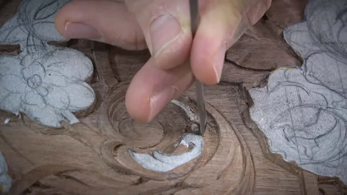 Slim tool held upright, its edge in the spiral