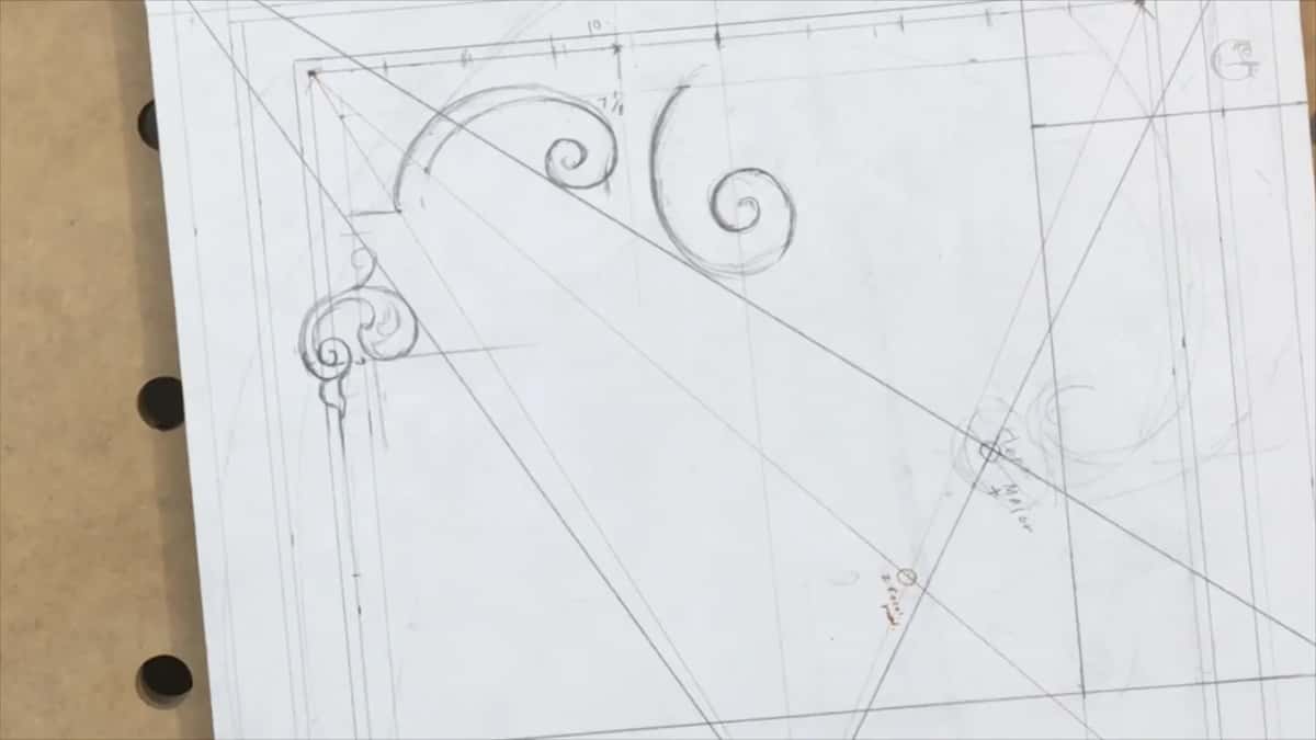 Two spirals and a leafy curl in the corner among the diagonals, with no hand in view